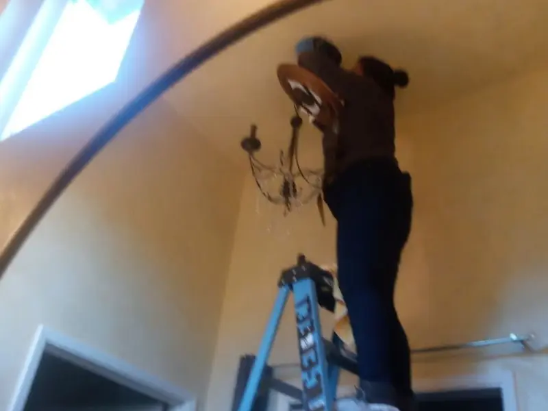 Electrician installing a chandelier in a La Crescenta-Montrose residence